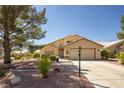 Charming single-story home with well-manicured landscaping and a welcoming front porch at 5413 Lochmor Ave, Las Vegas, NV 89130