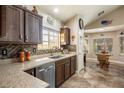 Bright kitchen featuring dark wood cabinetry, granite countertops, and tile backsplash at 5413 Lochmor Ave, Las Vegas, NV 89130