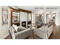 Open-concept living room with hardwood flooring, stylish furniture, and a modern fireplace at 9101 Alta Dr # 1202, Las Vegas, NV 89145