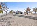 Two-story home with gray gravel, a paved drive, solar panels and a basketball court in the backyard at 7135 Polaris Ave, Las Vegas, NV 89118