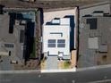 Aerial view of a modern home with solar panels, a pool, and meticulously landscaped front yard at 510 Duvet Ct, Henderson, NV 89012
