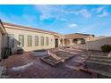 Charming brick patio with planter beds and access to the house via an arched doorway at 1430 Red Rock Dr, Pahrump, NV 89048