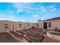 Enclosed backyard featuring a desert landscape, a small round pool, and a charming wrought-iron gate at 1430 Red Rock Dr, Pahrump, NV 89048