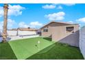 Landscaped backyard with putting green and storage shed at 4657 Warner Pl, Las Vegas, NV 89115