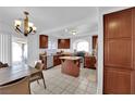Spacious kitchen featuring wooden cabinetry, tile floor, and a central island at 10568 Salmon Leap St, Las Vegas, NV 89183
