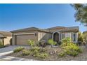 Charming single-story home with manicured landscaping and a two-car garage at 10315 Premia Pl, Las Vegas, NV 89135