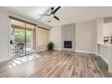 Bright living room featuring hardwood floors, fireplace, and access to the outdoor patio at 10315 Premia Pl, Las Vegas, NV 89135