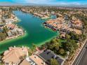 Aerial view of waterfront homes and a lake at 3120 Mediterranean Dr, Las Vegas, NV 89117