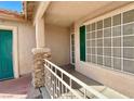 Small front porch with stone accents and a green door at 5034 Sail Rock Pl, North Las Vegas, NV 89031