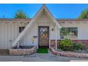 Front entryway with brick trim, a decorative door and a small garden area at 2213 W Oakey Blvd, Las Vegas, NV 89102