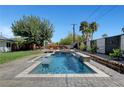 Backyard pool features a modern design with a cascading waterfall feature at 2213 W Oakey Blvd, Las Vegas, NV 89102