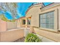 Charming single-story home featuring stucco walls, a gated front courtyard, and desert landscaping at 3665 Bella Legato Ave, North Las Vegas, NV 89081