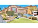 Single-story home with well-manicured artificial turf and desert landscaping at 3665 Bella Legato Ave, North Las Vegas, NV 89081