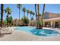 Community pool with lounge chairs and palm trees at 2300 E Silverado Ranch Blvd # 1094, Las Vegas, NV 89183