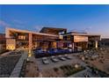 Striking contemporary home with a large pool, poolside seating, and meticulously landscaped grounds at 685 Dragon Peak Dr, Henderson, NV 89012