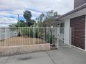View of the front yard with desert landscaping and a white fence for enhanced curb appeal at 1828 Hassett Ave, Las Vegas, NV 89104