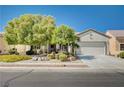 Charming single-story home with mature trees, well-maintained landscaping, and a two-car garage at 7457 Widewing Dr, North Las Vegas, NV 89084