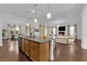 Spacious open floor plan with kitchen island, hardwood floors, and bright natural light at 45 Moltrasio Ln, Henderson, NV 89011