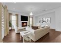 Bright living room boasts fireplace, hardwood floors, large windows, and stylish decor at 45 Moltrasio Ln, Henderson, NV 89011