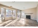 Bright living room with fireplace and wood-look floors at 8209 Crows Nest Ln, Las Vegas, NV 89128
