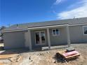 Exterior of new construction featuring a covered patio with pillars, ready for landscaping at 220 N David St, Pahrump, NV 89060