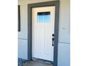 Close up of a white craftsman style front door with glass insert at 220 N David St, Pahrump, NV 89060