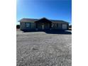 Charming single-story home featuring a gravel yard and attached garage at 220 N David St, Pahrump, NV 89060