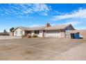 Well-maintained home featuring a spacious driveway, brick accents, and desert landscaping at 360 E Kimberly Dr, Henderson, NV 89015