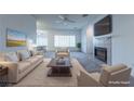 Bright living room features a fireplace, ceiling fan, plush carpet, and modern furnishings at 1200 Golf Club Dr, Laughlin, NV 89029