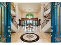 Impressive foyer with a grand staircase, marble floors, and designer details at 1309 Imperia Dr, Henderson, NV 89052