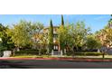Elegant two-story home with lush landscaping, mature trees, and a circular driveway at 1309 Imperia Dr, Henderson, NV 89052