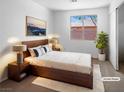 Cozy staged bedroom with ample light, plush carpet, and a large window at 1195 Sunfire St, Henderson, NV 89014
