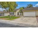 Inviting single-story house featuring a well-kept lawn, mature tree, and attached two-car garage at 5701 Pearldrop Ave, Las Vegas, NV 89107