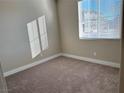 Simple bedroom with carpeted floors and window blinds at 9902 Belikove Manor Ave, Las Vegas, NV 89178
