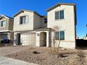 Two-story house with a brown garage door and landscaped front yard at 9902 Belikove Manor Ave, Las Vegas, NV 89178