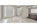 Two-story house entryway with tile floor and powder room at 10914 Fintry Hills St, Las Vegas, NV 89141