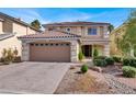 Two-story house with tan exterior, brown roof, and paved driveway at 10914 Fintry Hills St, Las Vegas, NV 89141