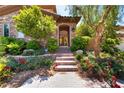 Landscaped entryway with brick steps leading to a front door with a security gate at 2804 Josephine Dr, Henderson, NV 89044