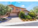 Two-story home featuring desert landscaping, stone accents, and a two-car garage at 2804 Josephine Dr, Henderson, NV 89044