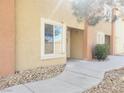 Exterior view of the home showing the front door, window, and landscaping at 3843 Terrazzo Ave # 0, Las Vegas, NV 89115