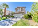 Two-story house with attached garage and palm trees at 2345 Silver Crew Pass, Henderson, NV 89052