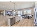 Modern kitchen with island, stainless steel appliances, and hardwood floors at 578 Jerry Bird Ct, Las Vegas, NV 89123