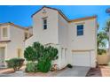Attractive stucco home boasts an attached garage, lush landscaping, and a well-maintained driveway at 6271 Sunset Spring Ave, Las Vegas, NV 89122