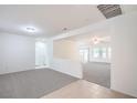 Bright and airy living room with neutral carpeting, fresh white paint, and an open concept layout at 7625 Fieldfare Dr, North Las Vegas, NV 89084