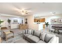 Open-concept living room and kitchen with a modern design and neutral color palette at 7625 Fieldfare Dr, North Las Vegas, NV 89084