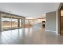 Open-concept layout boasts tile floors, large windows, and a seamless transition to the kitchen and dining area at 1438 Dire Wolf Ave, North Las Vegas, NV 89084