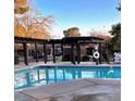 Inviting community pool area with shaded pergola at 310 Brookside Ln # B, Las Vegas, NV 89107