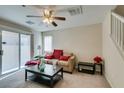 Bright living room with a comfy sofa and sliding glass door to backyard at 4750 Newby Hall Ct, Las Vegas, NV 89130