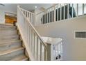 Modern staircase with light wood flooring and white railings at 4750 Newby Hall Ct, Las Vegas, NV 89130