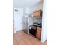 Traditional kitchen with stainless steel appliances and tile flooring at 2509 Canosa Ave, Las Vegas, NV 89104